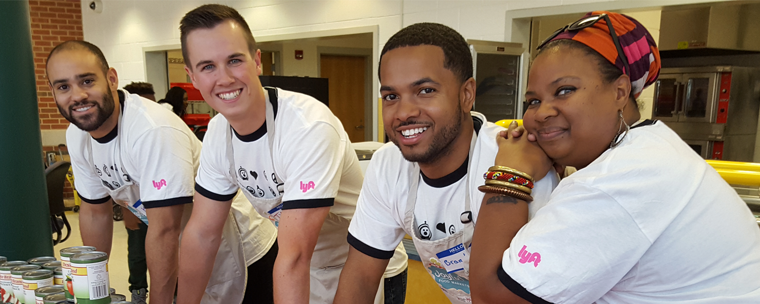 A group of Community Grants recipients smiling at a food drive.