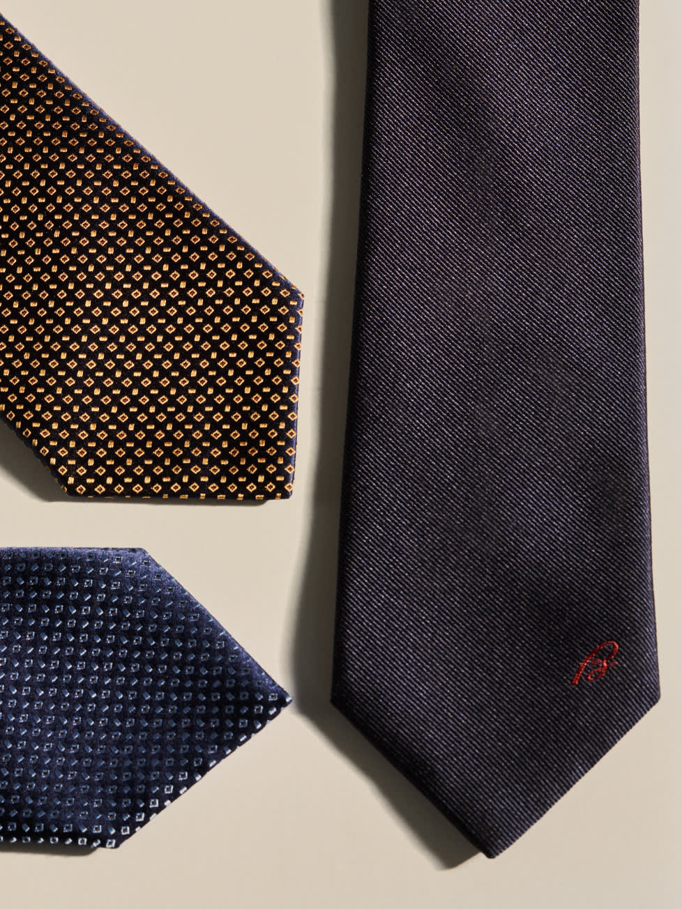 Three Brioni made-to-order ties in different fabrics and patterns