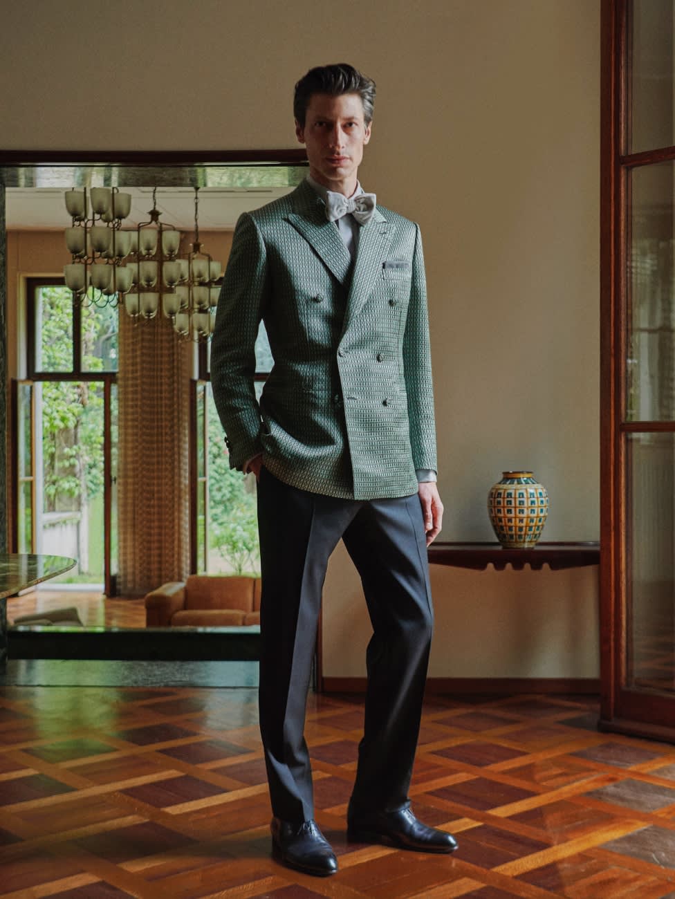 FW21 model wearing a Brioni green evening jacket