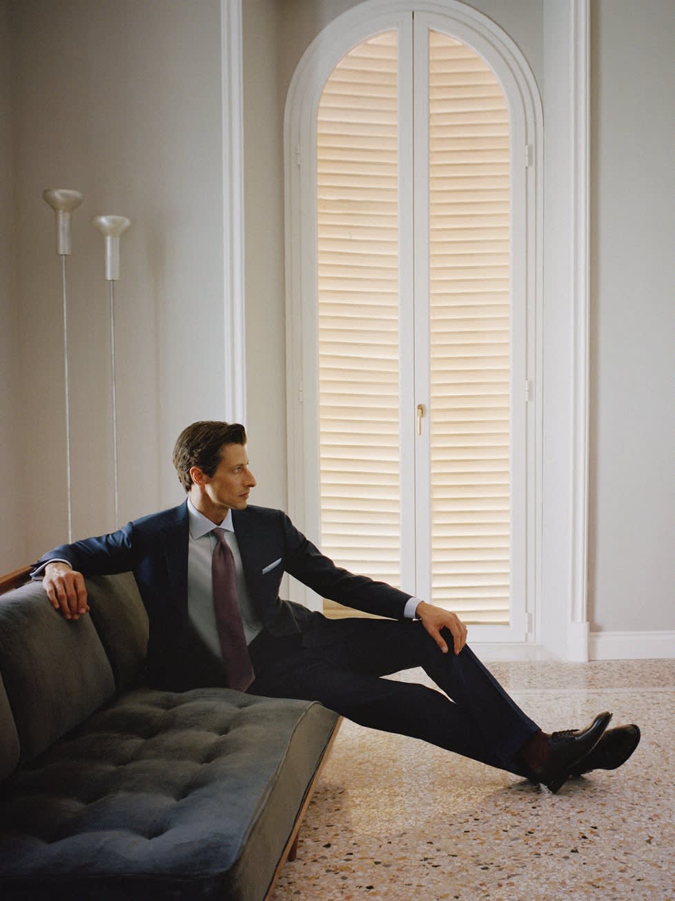 Male model wearing a navy blue suit in wool and silk