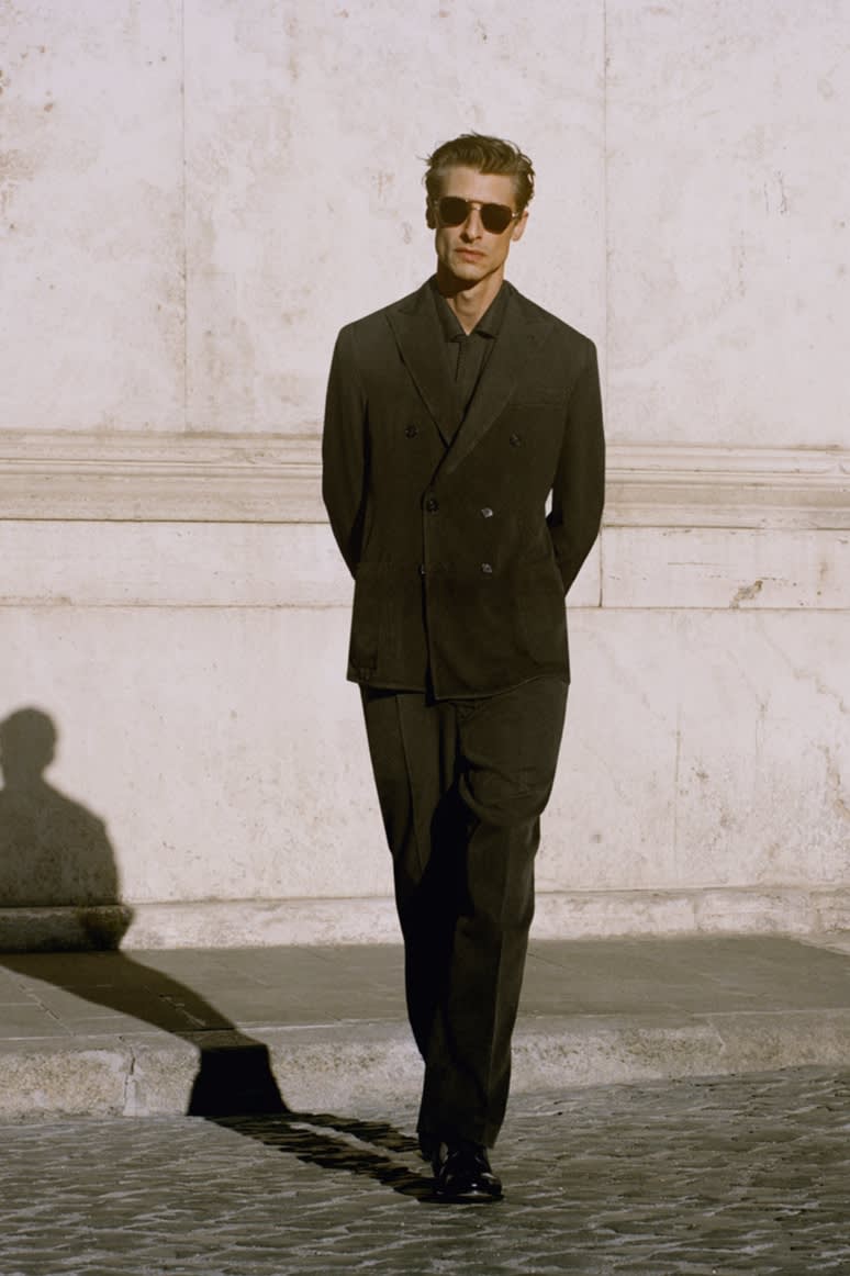 Male model wearing a dark green washed silk double-breasted jacket and trousers