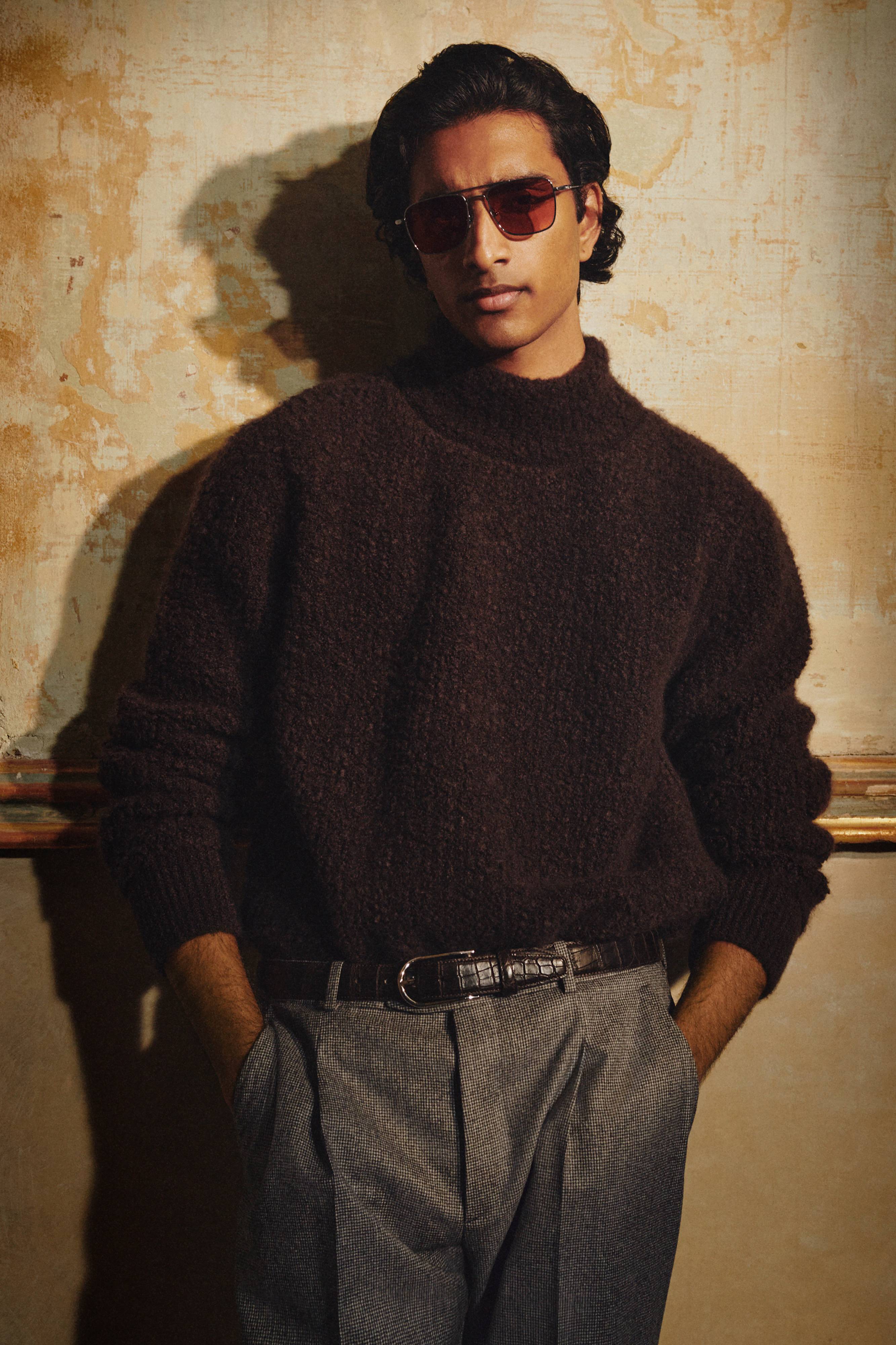 Brioni model wearing high neck sweater and sunglasses from fall winter 22