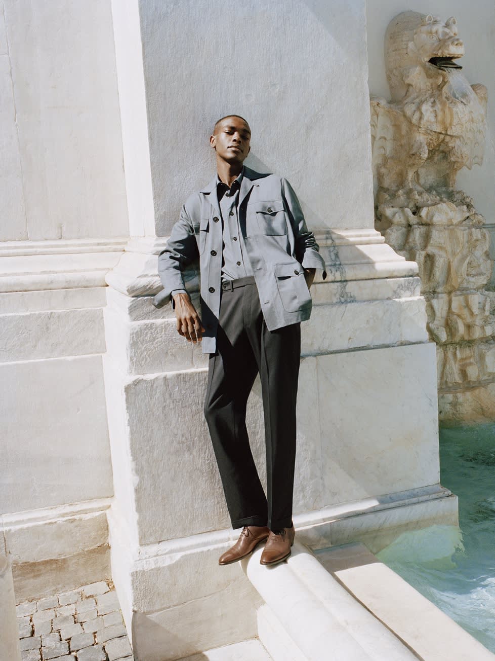 Male model wearing a wool and silk sahariana, double splittable shirt, and wool trousers