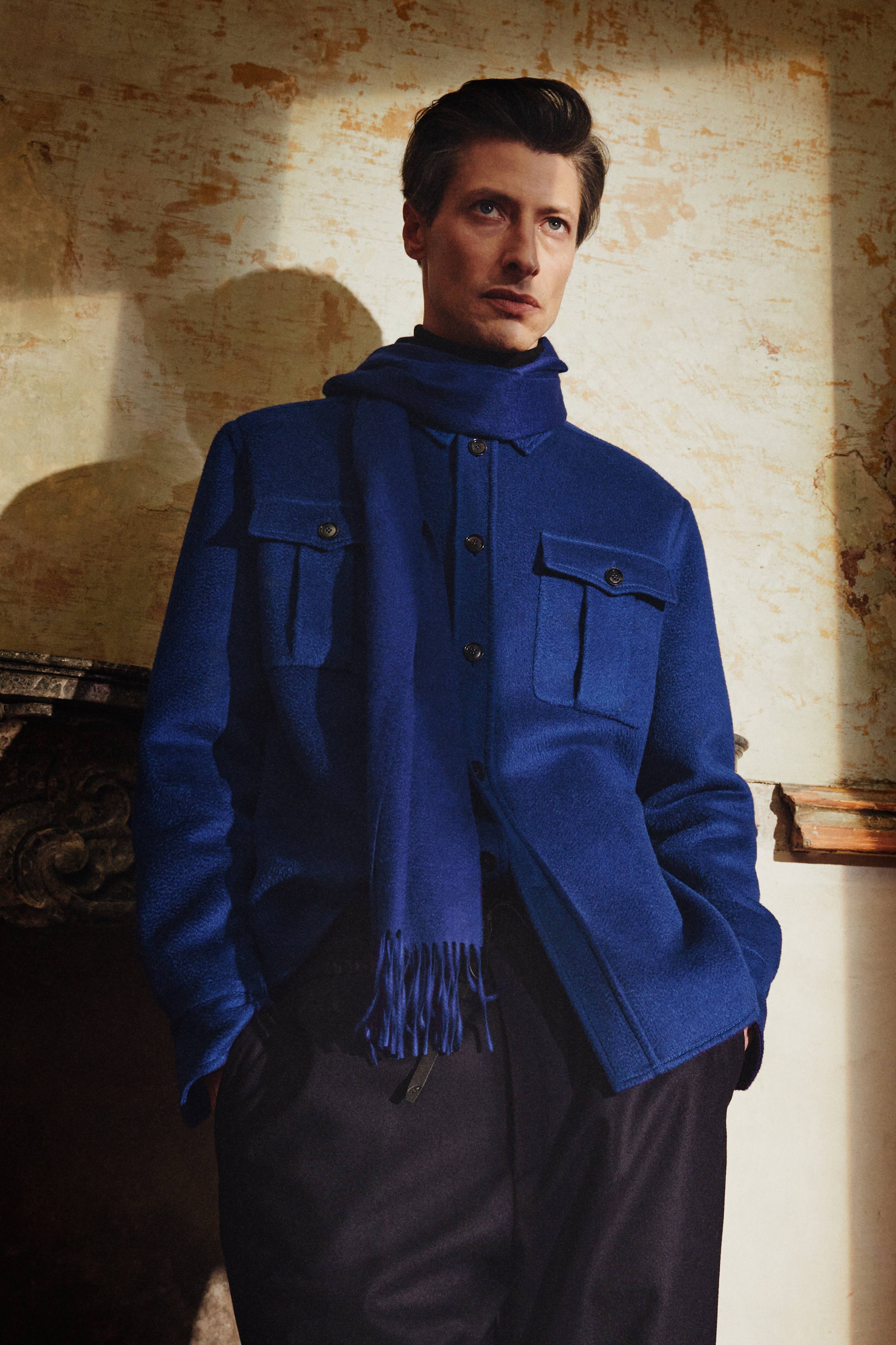Brioni model wearing royal blue jacket and scarf from fall winter 22