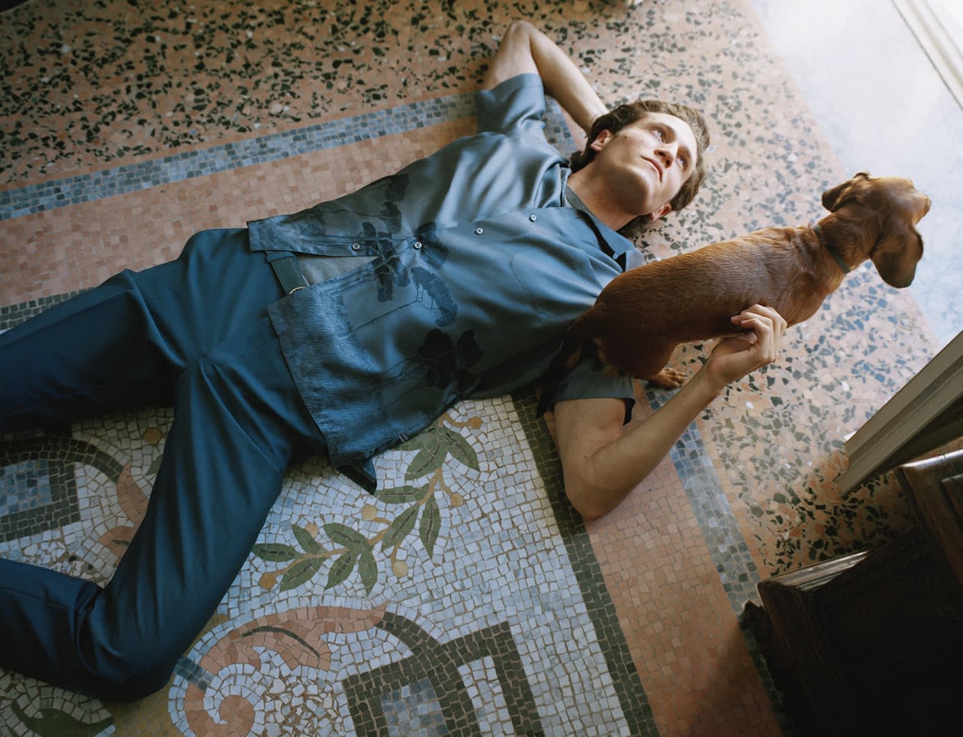 Male model wearing a blue printed silk shirt and blue wool trousers