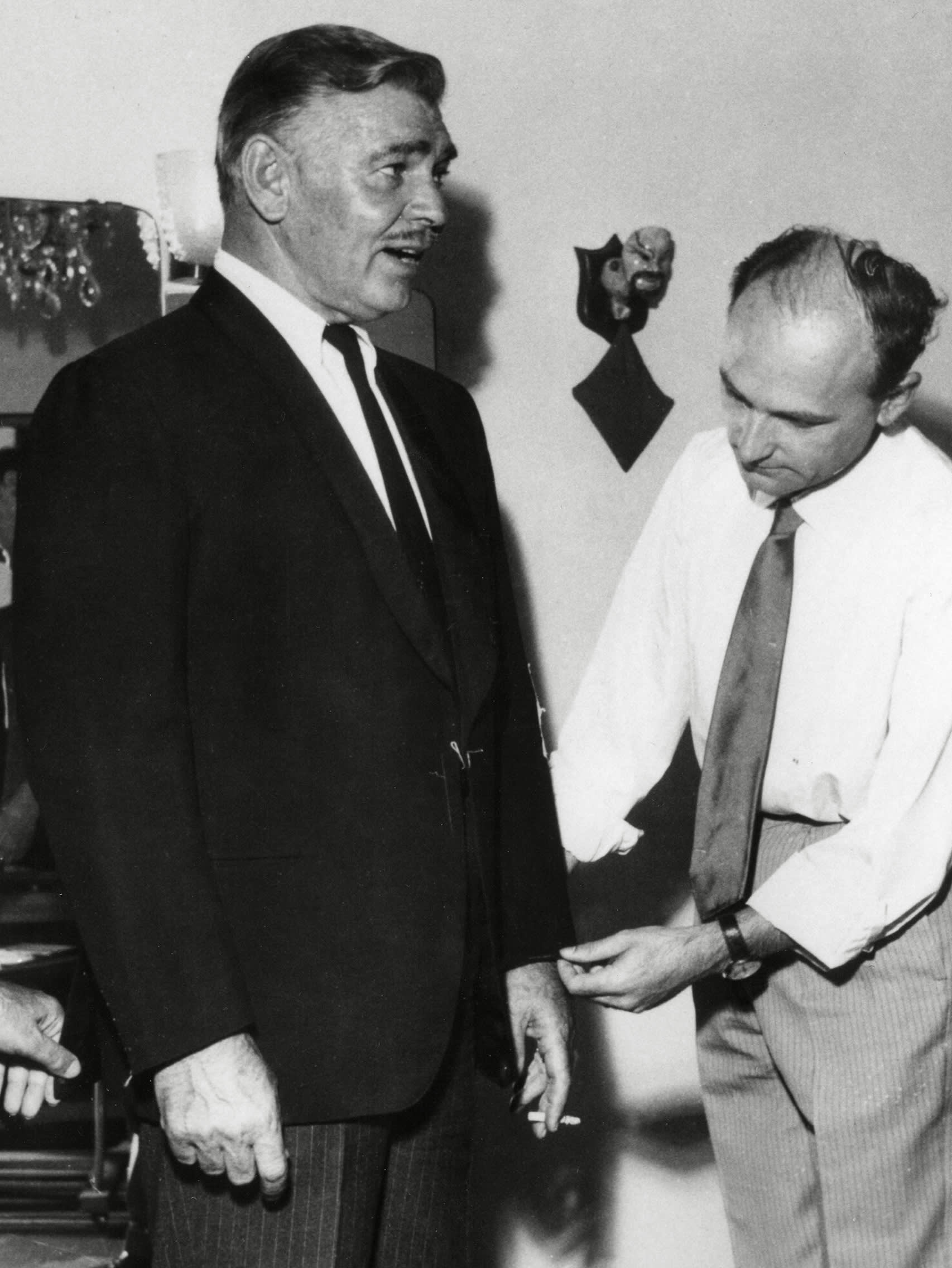 Actor Clark Gable is fitted for a Brioni suit