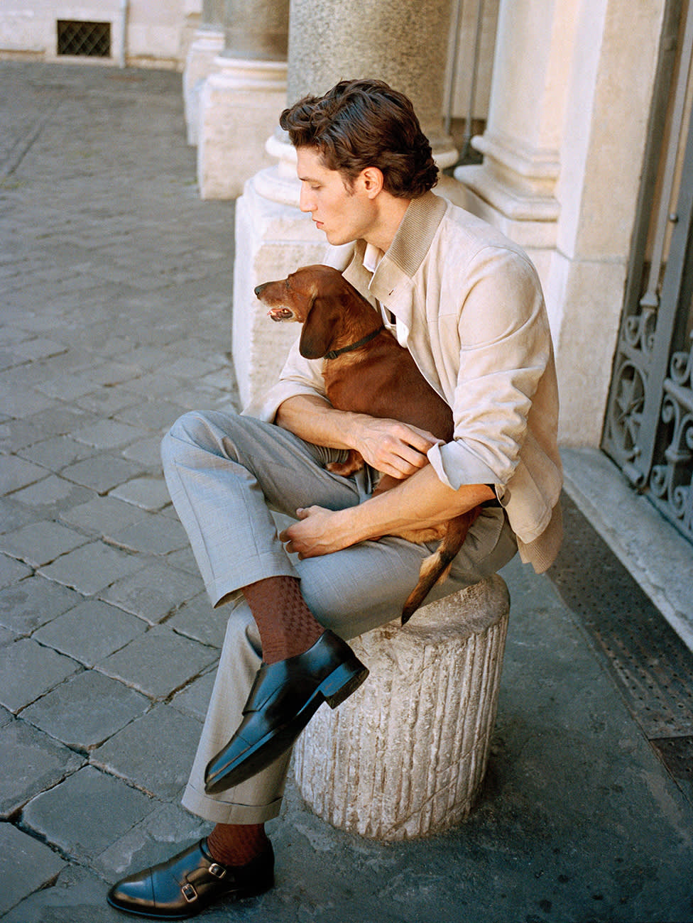 Male model wearing a Brioni suede blouson and grey wool trousers