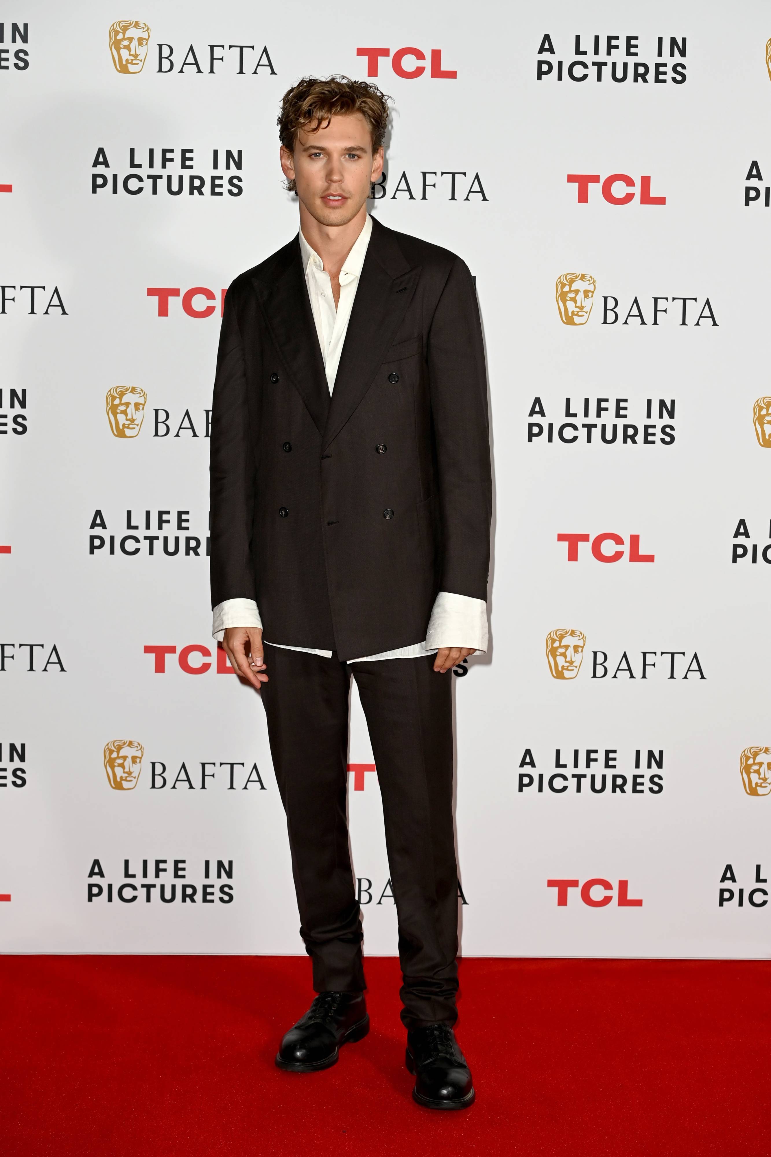 Austin Butler wearing a Brioni black suit