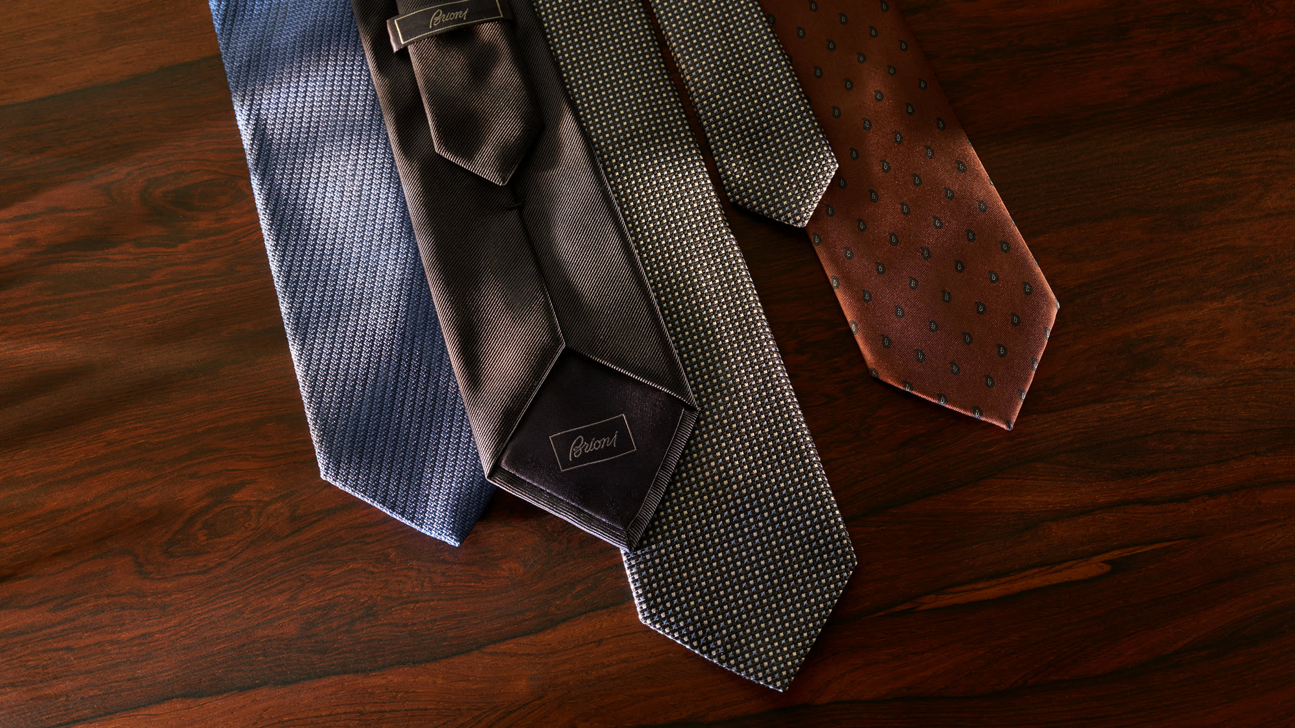 Four Brioni made-to-order ties in different fabrics and patterns