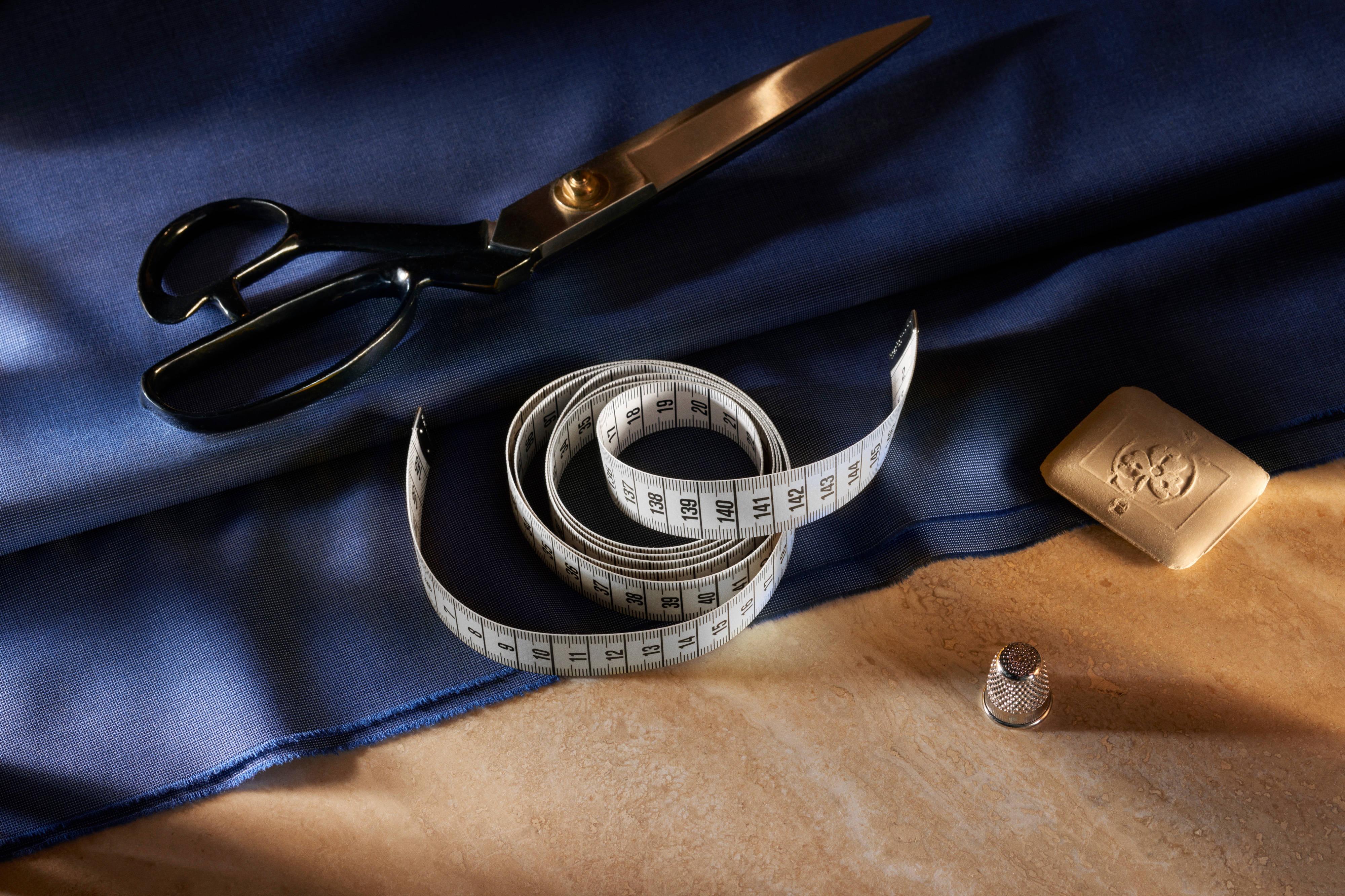 The tools of the Brioni master tailor: scissors, measuring tape, chalk and thimble