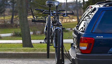 Two bikes on a bike rack that is attached to the back of car