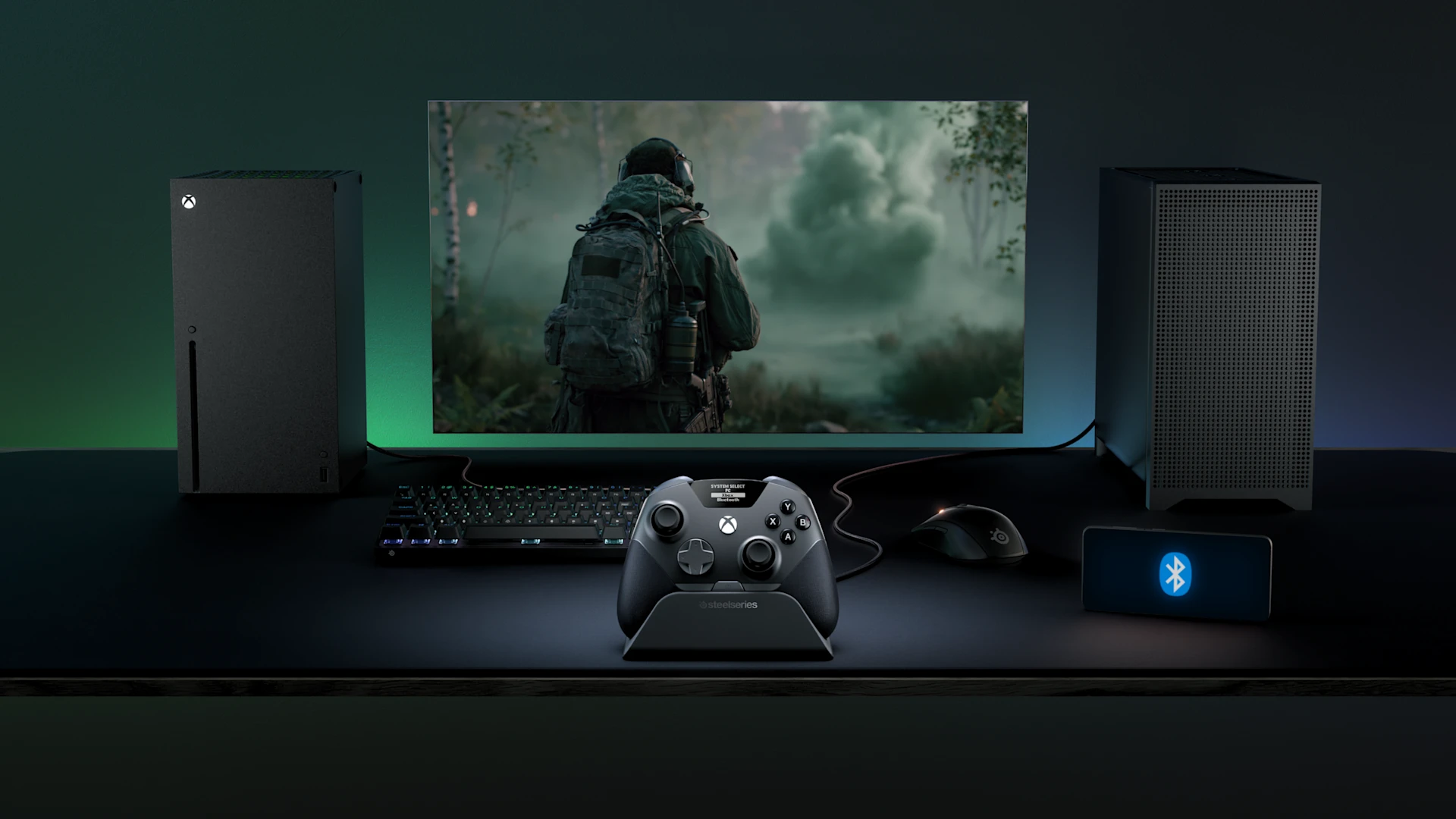 游戏配置包括 Xbox Series X、台式机主机、显示器以及放置在底座上的 SteelSeries Aeon Pro 手柄。
