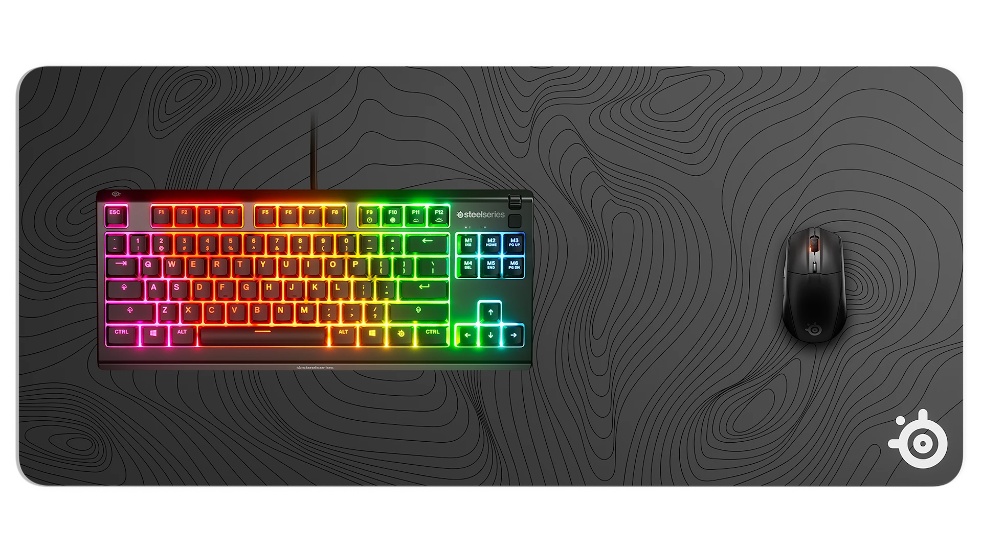 SteelSeries gaming mouse, topographic mousepad, and RGB mechanical keyboard.