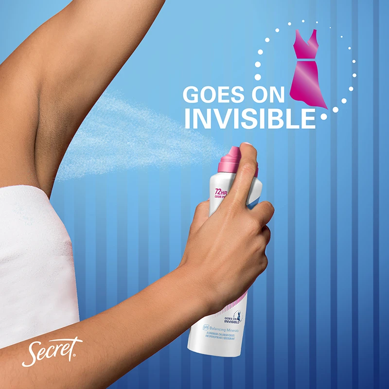 A person spraying her armpit