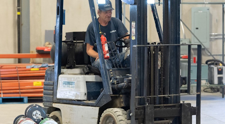 man driving forklift