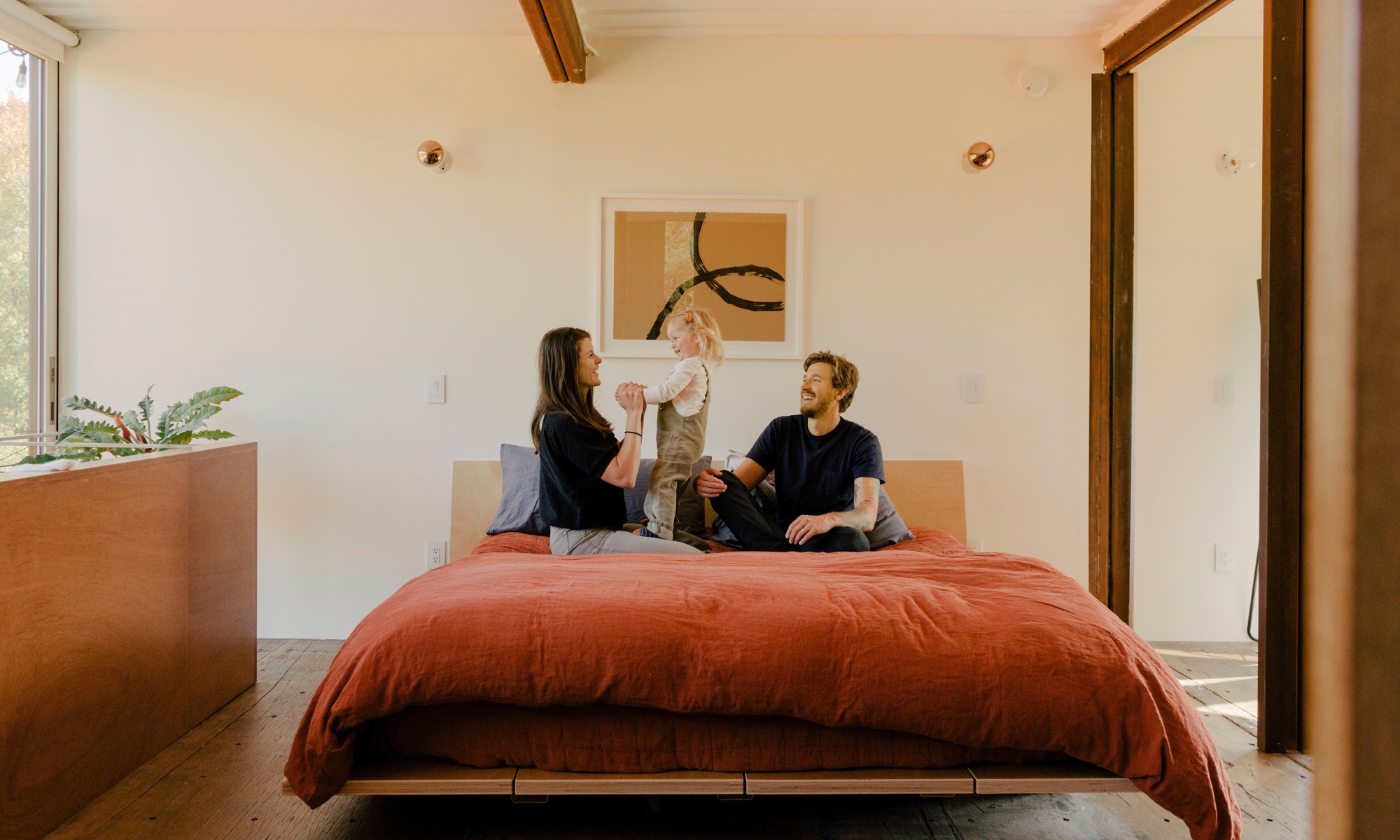 A modern bedroom with a Floyd bed and a family.