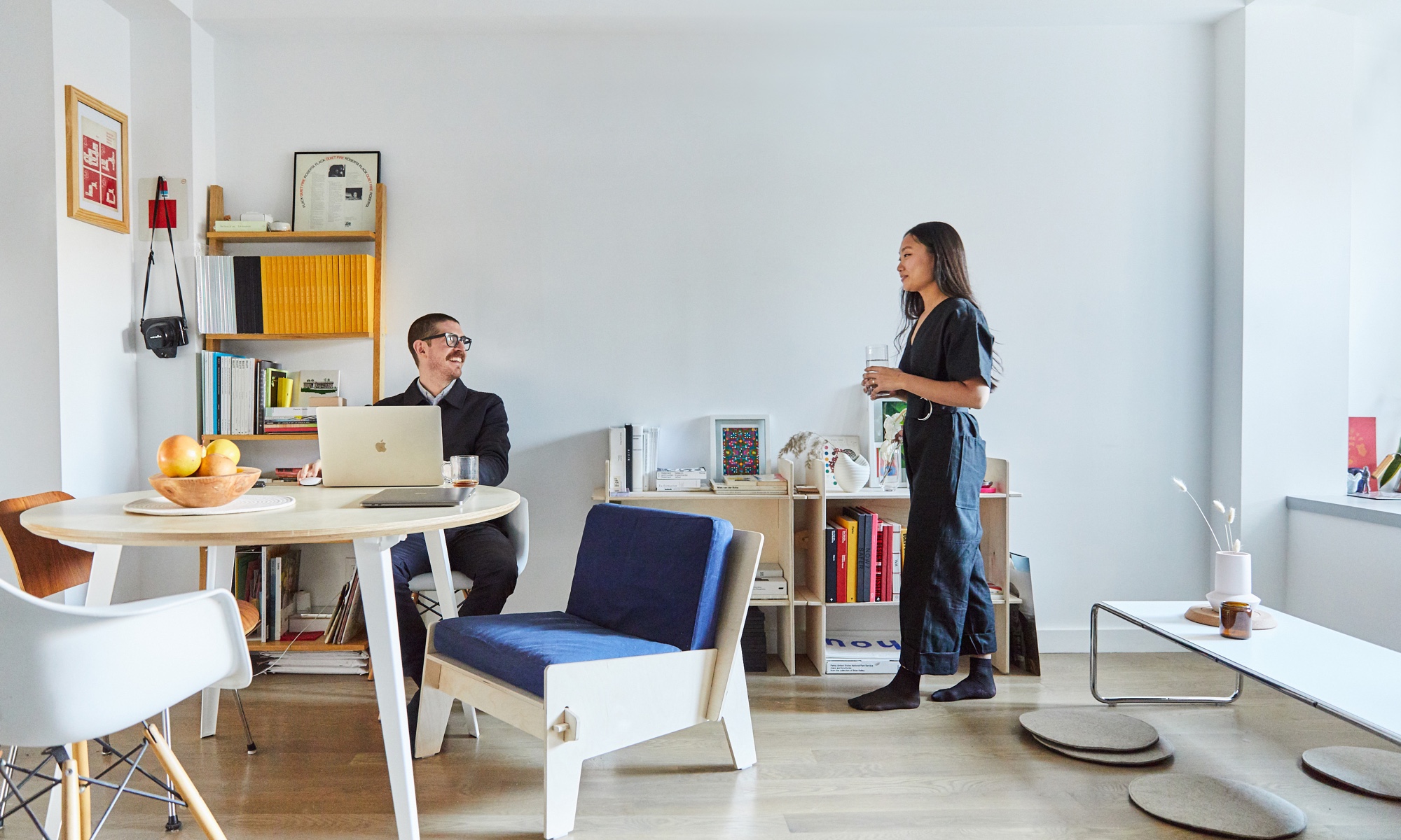 Estee + Jesse in their NYC apartment with a birch Floyd table