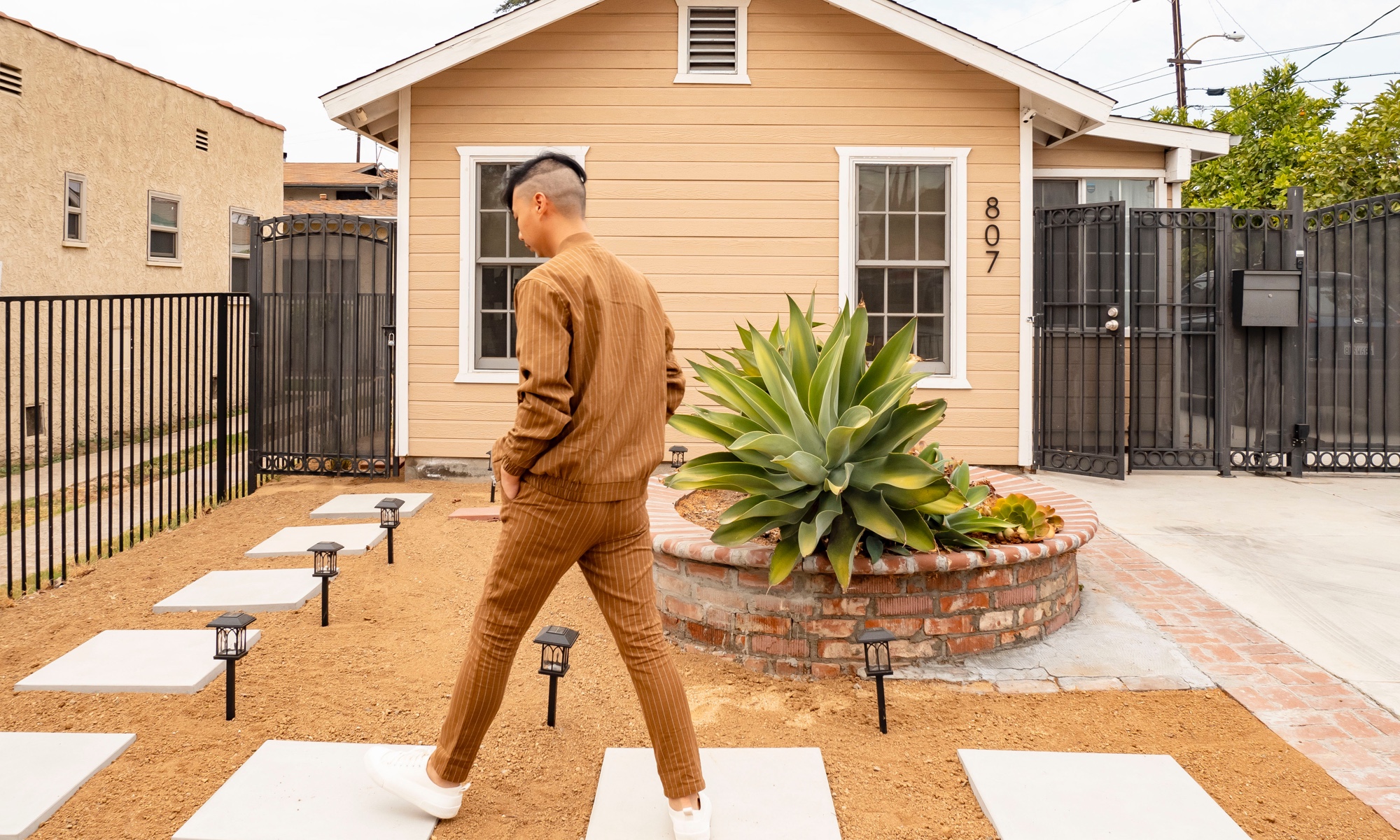 Tommy Lei outside his Alhambra home.