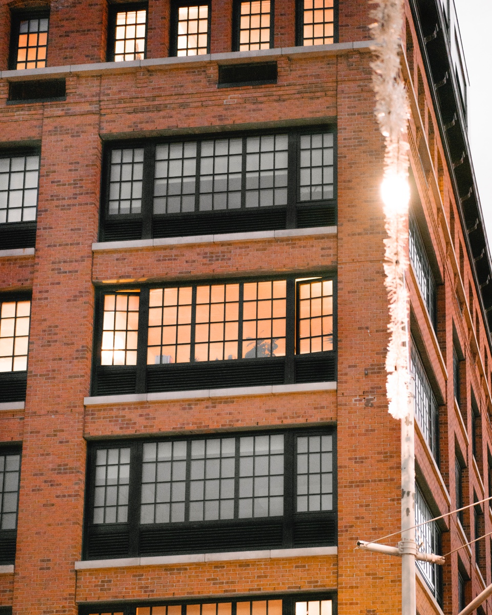 Their apartment has huge windows overlooking the neighborhood.