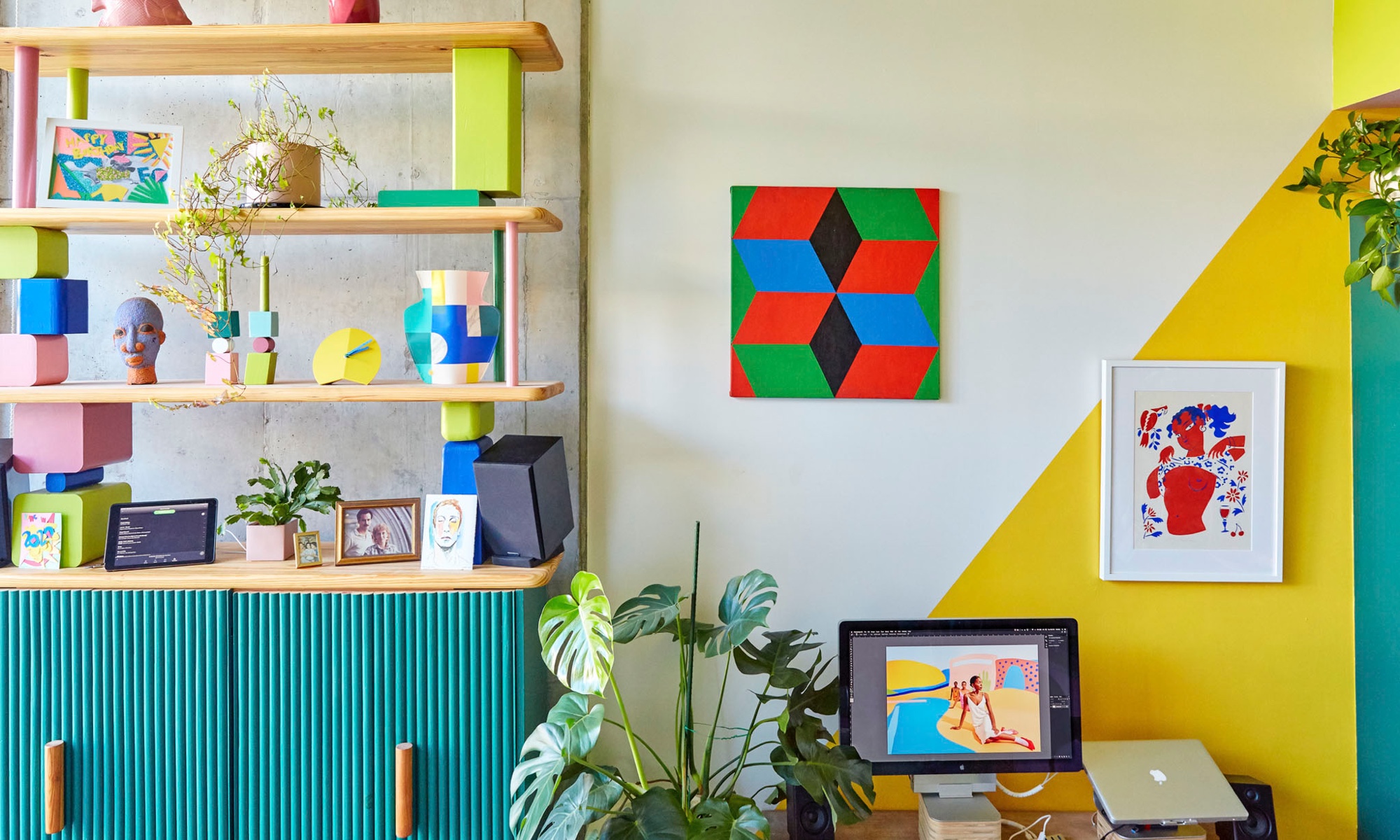 The home also serves as a workspace for the creative pair, and a cheerful yellow triangle defines the desk area.