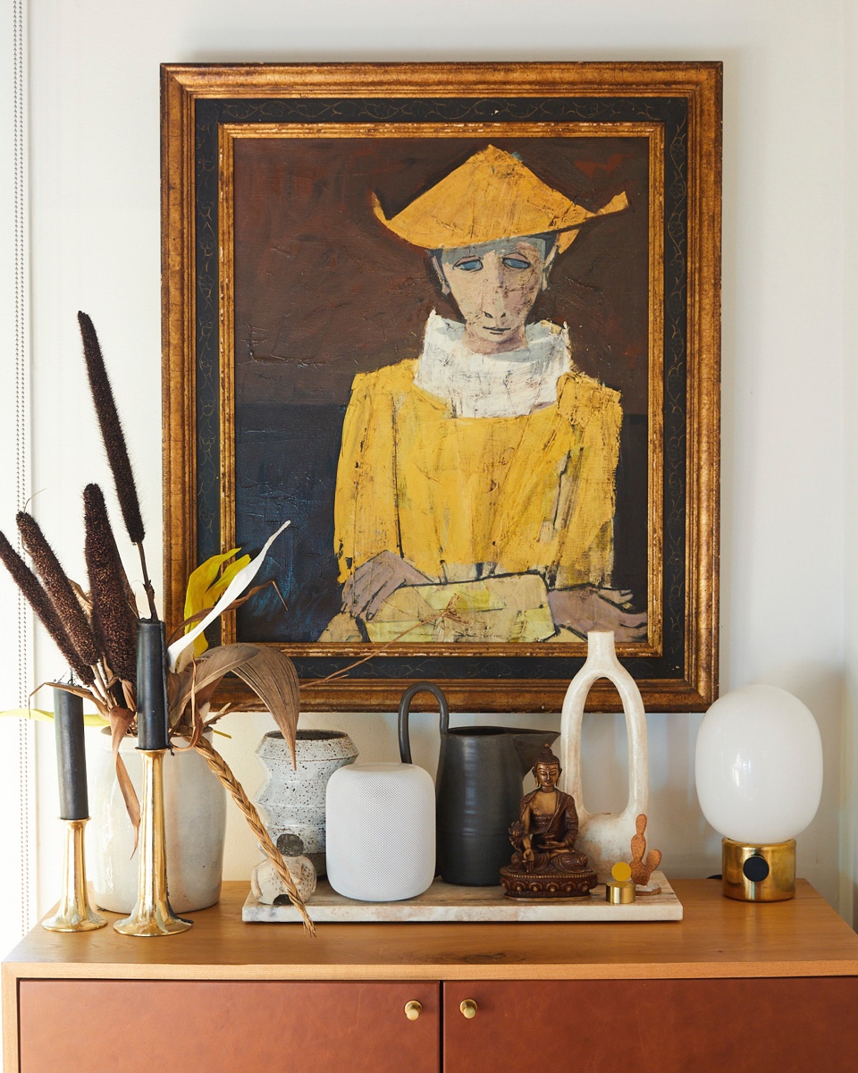 A family-heirloom painting watches over the dining area.