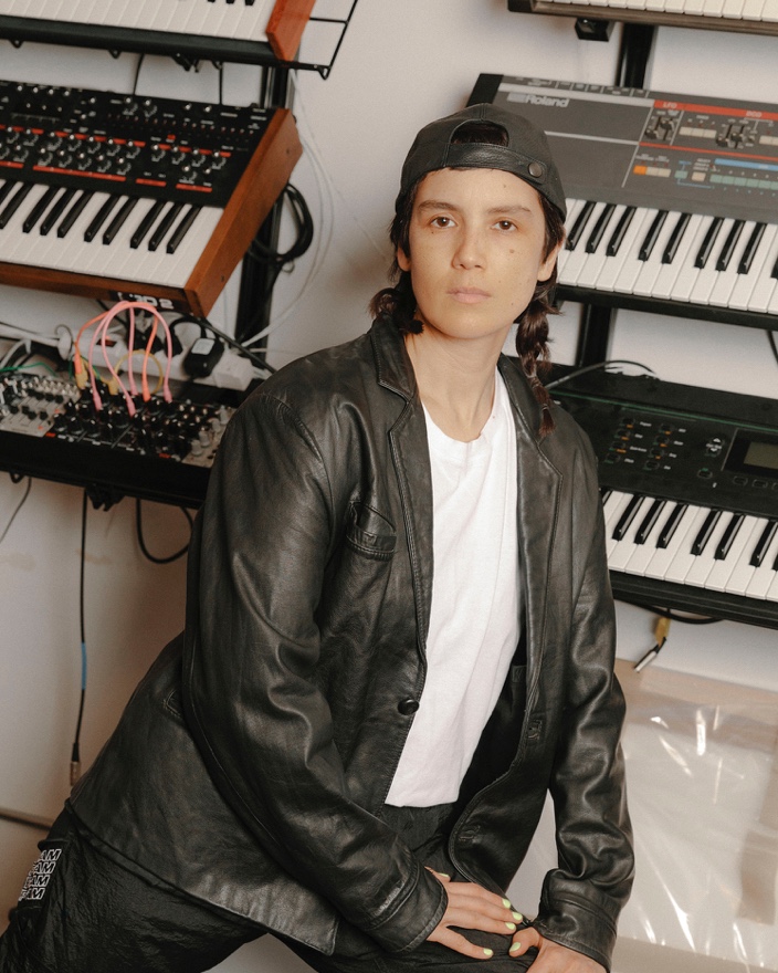 Kim Ann in front of her collection of keyboards.