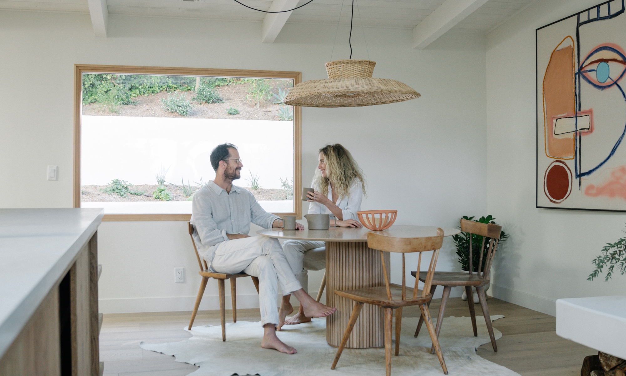 The couple have a taste for minimal pieces, but the space feels welcoming thanks to warm neutrals and lots of exposed wood.