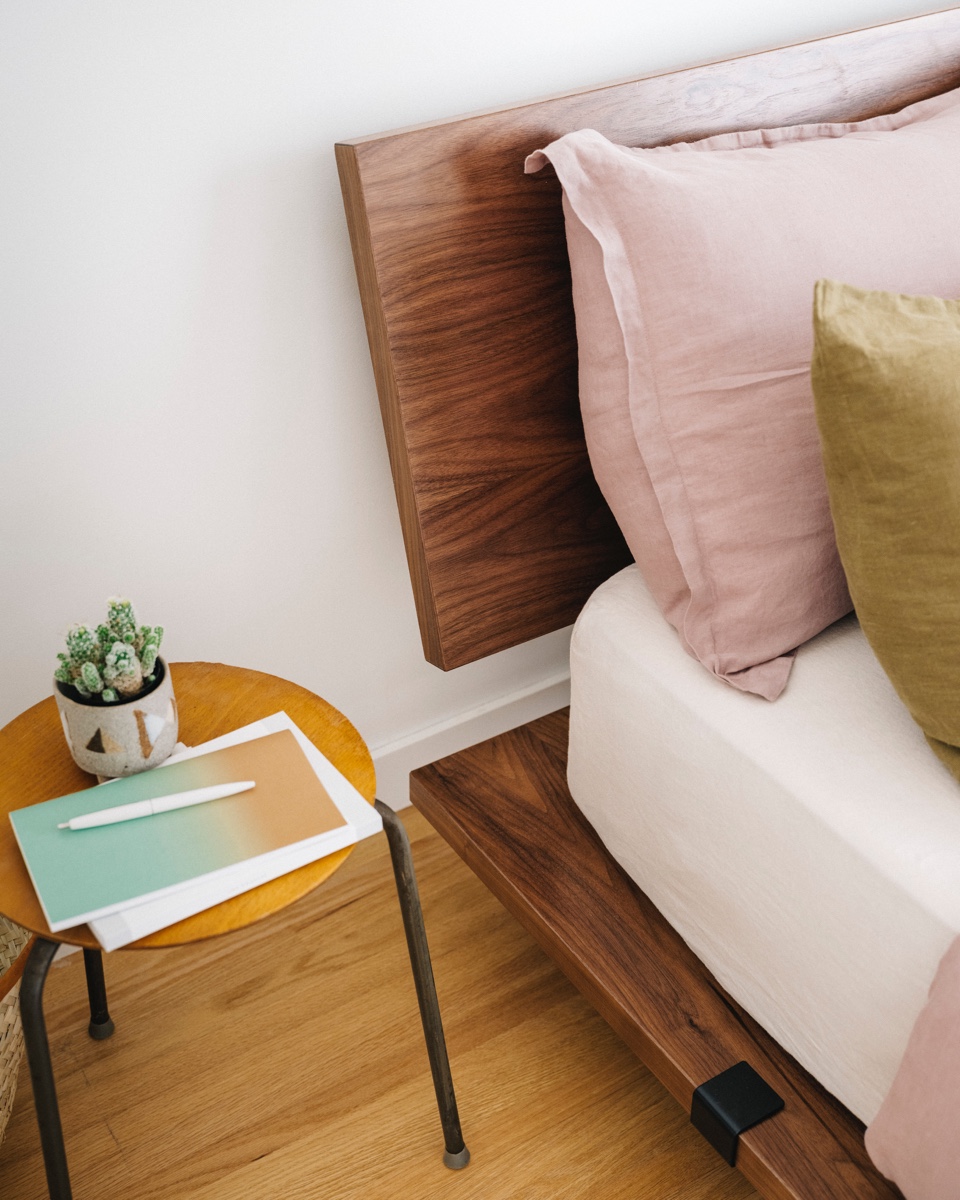 Walnut Floyd platform bed and headboard on lighter wood floors