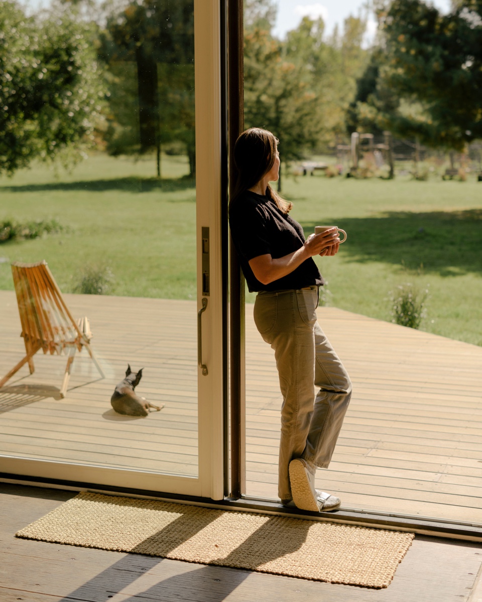 Victoria Masters overlooking a wide deck in upstate new york at her modern home.