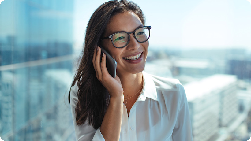 happy-businesswoman-talking-phone-cityscape-1440x1120.jpg