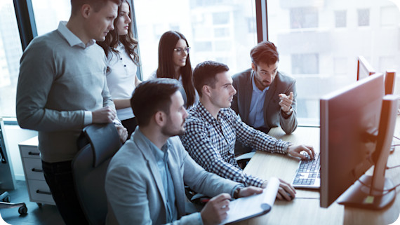 Software engineers working in office on project together.