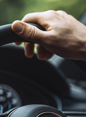 Automotive Ethernet closeup-hand-driving-870x490