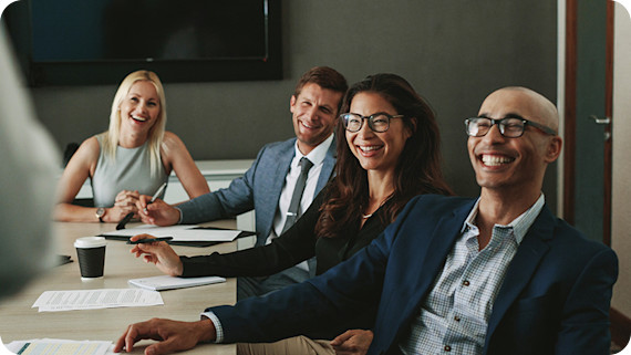 About Us Business people smiling during meeting in office.