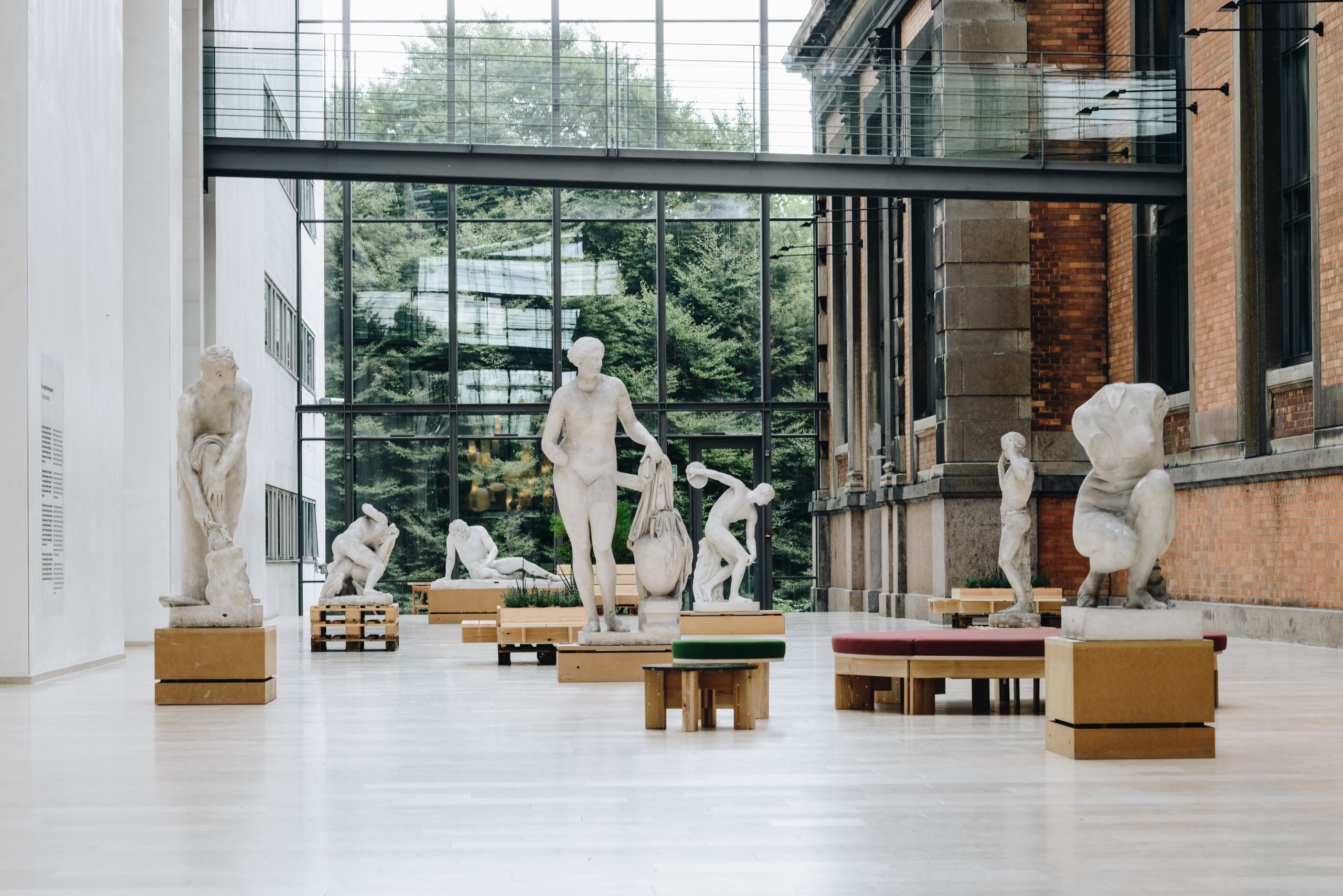 Sculptures in a wide open space in a museum.