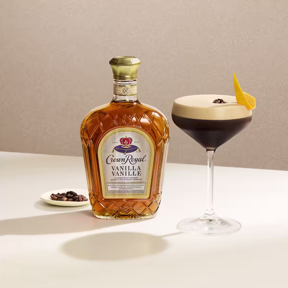 A bottle of Crown Royal Vanilla next to a Crown Espresso Martini cocktail