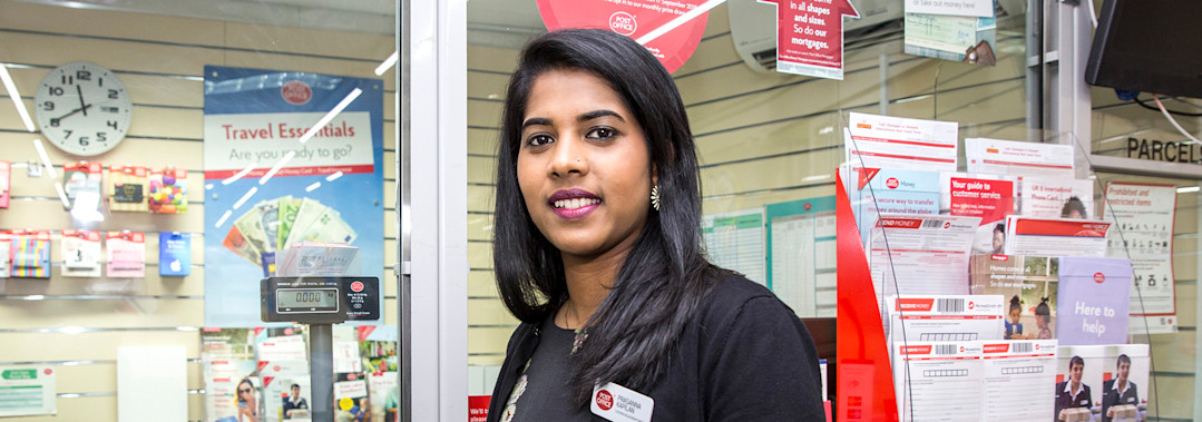 Woman standing in front of Post Office counter Woman standing in front of Post Office counter