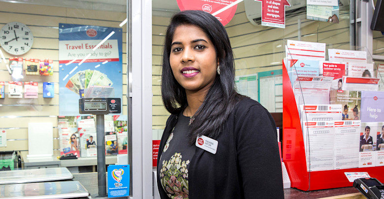 Woman standing in front of Post Office counter