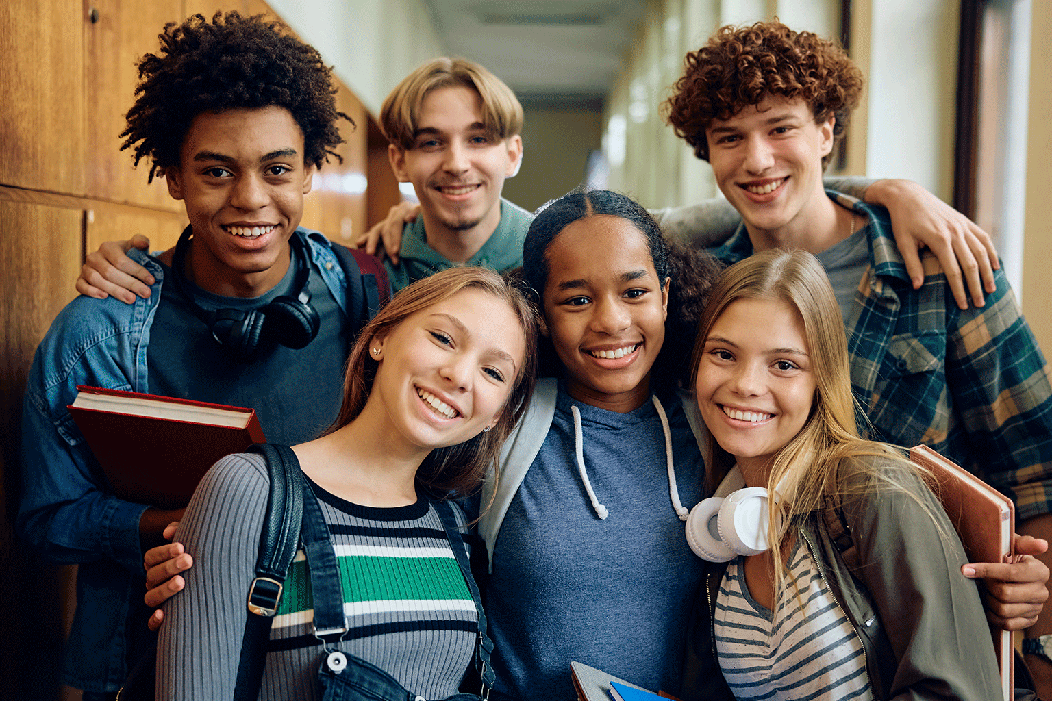 Students hanging out together, smiling for a group photo. Students hanging out together, smiling for a group photo.