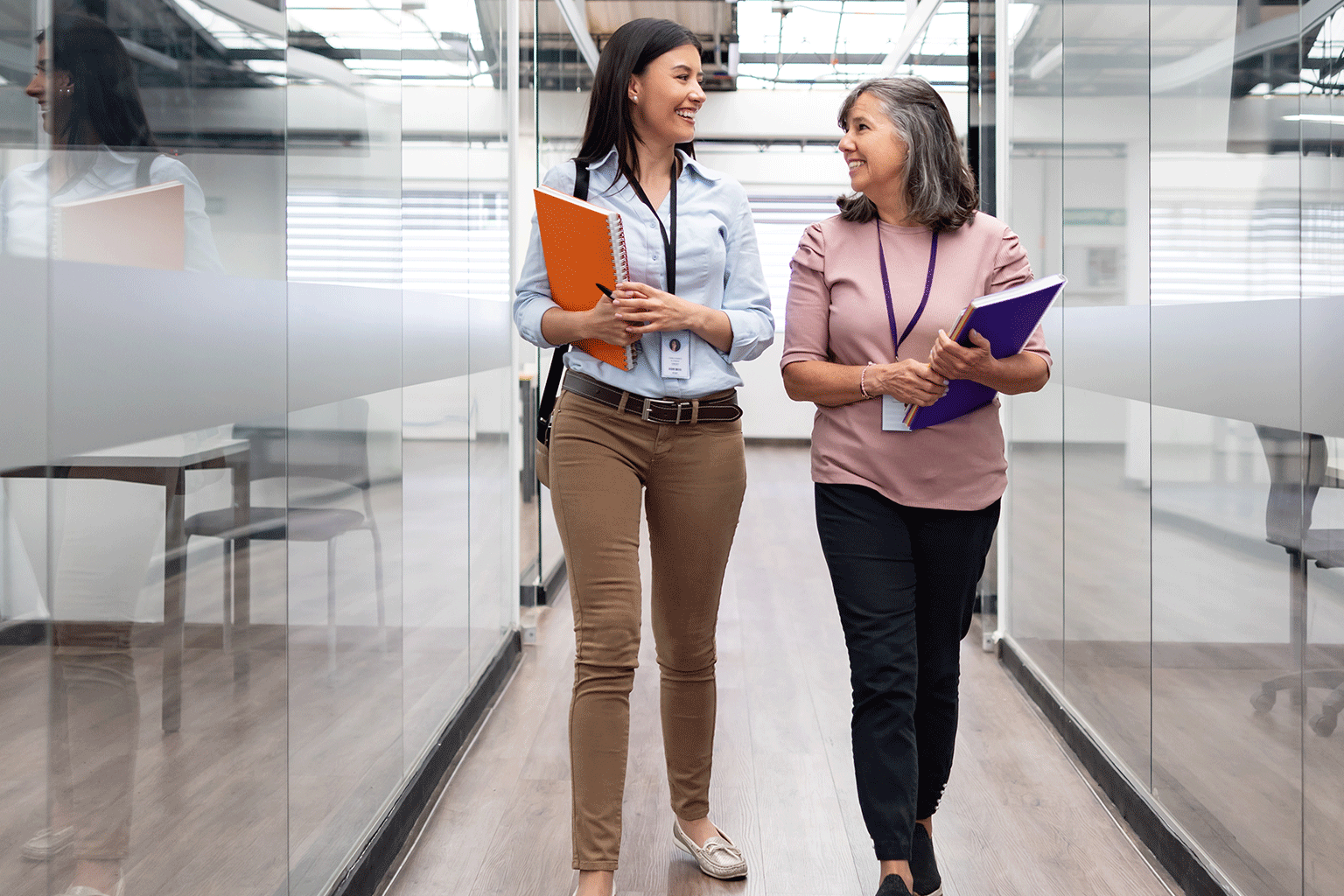 Teachers chatting while walking in the hallway. Teachers chatting while walking in the hallway.