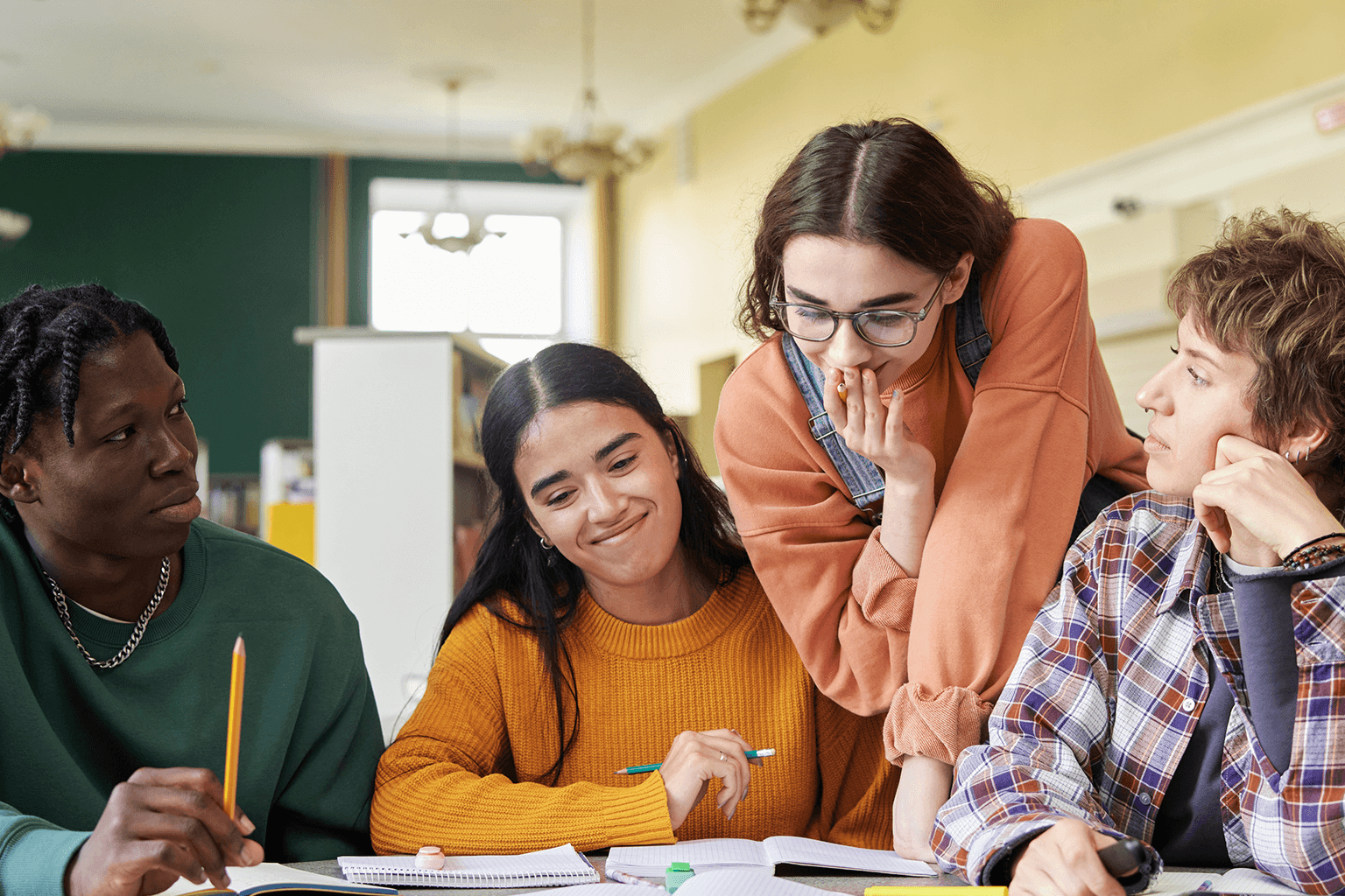 High school students collaborating on a project together. High school students collaborating on a project together.