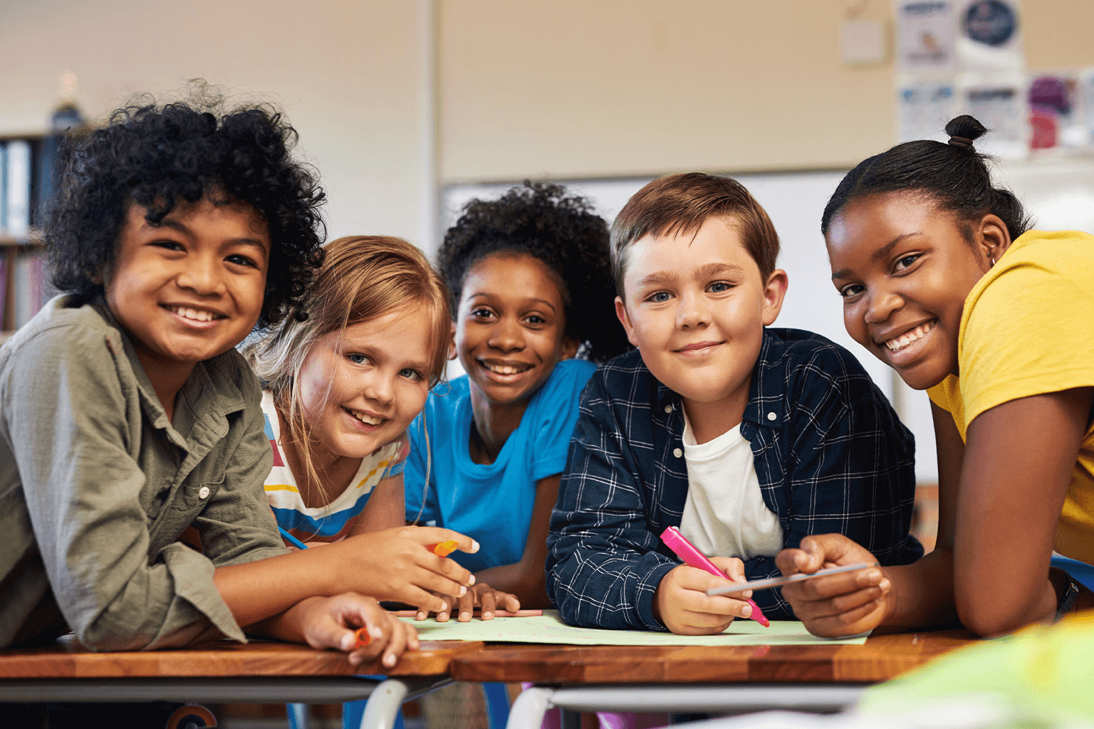 Students are working together around a table. Students are working together around a table.