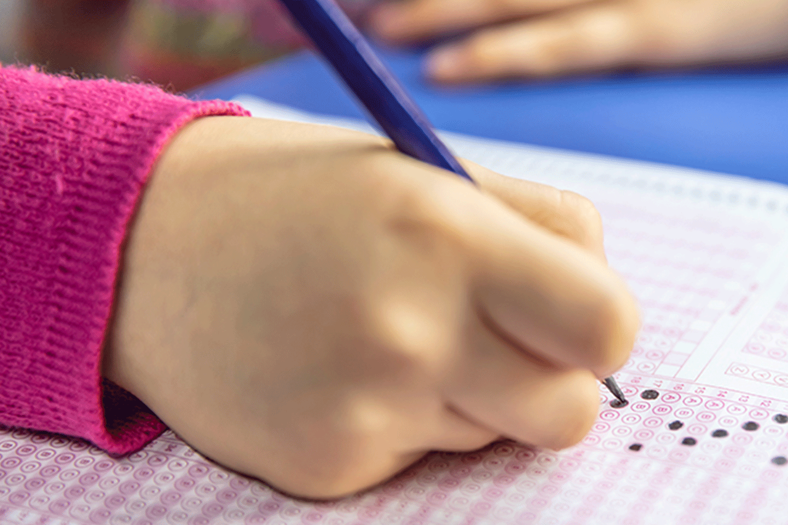 A student filling in a standardized test bubble sheet. A student filling in a standardized test bubble sheet.