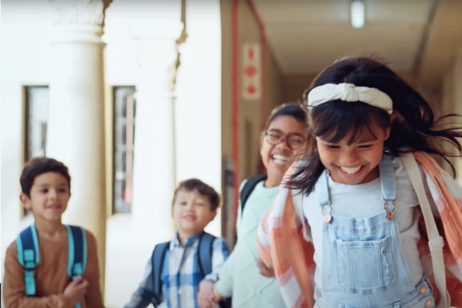 Kids running in a hallway together. Kids running in a hallway together.