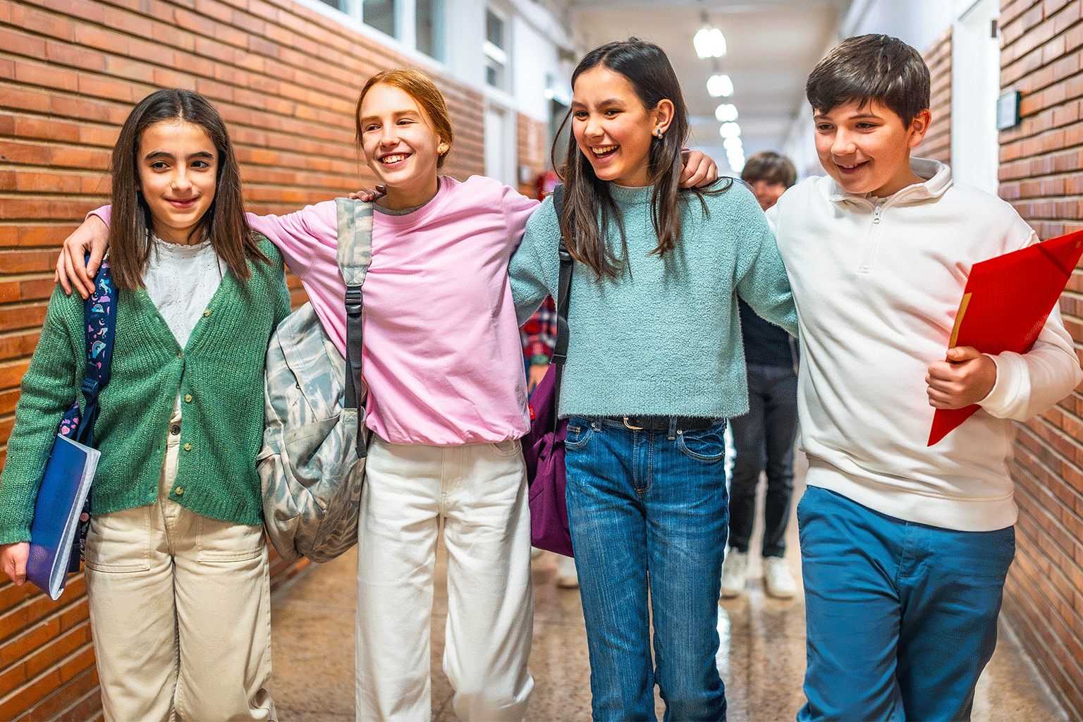 Kids smiling together in a hallway.  Kids smiling together in a hallway.