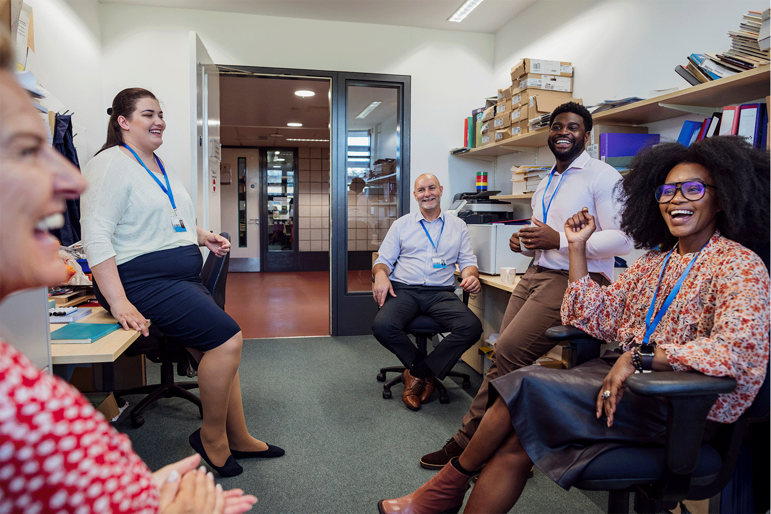 Teachers gathered together in the breakroom. Teachers gathered together in the breakroom.
