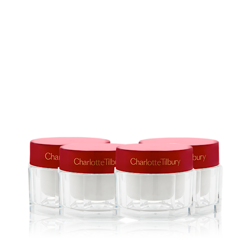 Limited Edition Year of Magic Skin still life A collection of pearly-white face creams in glass jars with eye-catching, red-coloured lids.