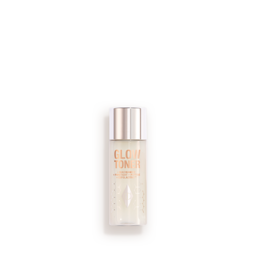 Mini Glow Toner Closed A large, clear bottle filled with luminous, cream-coloured watery toner with a silver-coloured lid.