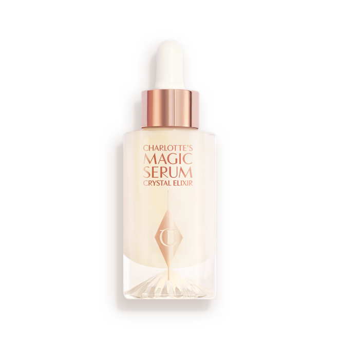 Charlotte's Magic Serum Crystal Elixir closed An award-winning, luminous, ivory-coloured serum in a glass bottle with a gold and white-coloured dropper lid.