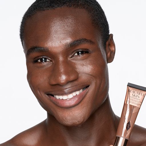 Beautiful Skin Foundation in 16C on a deep-tone model Deep-tone male brunette model with brown eyes wearing a skin-like foundation with a flawless, dewy finish.