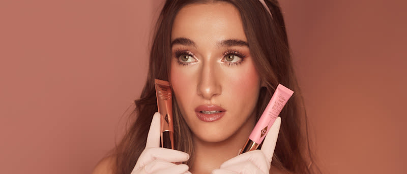 Cheek Makeup Tutorials Blog Posts Fair model with brunette hair holding two liquid blush wands